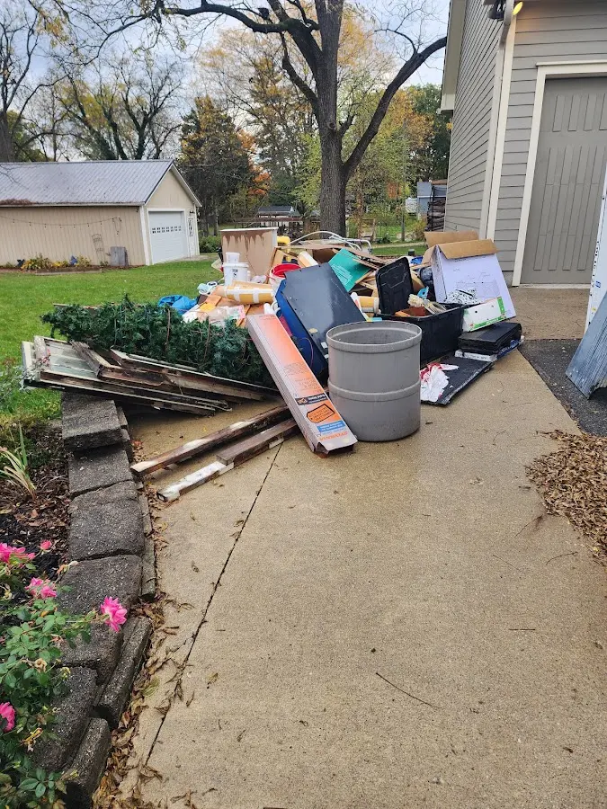 Dumpster being loaded with debris for 12 Yard Dumpster Rental in Waukee